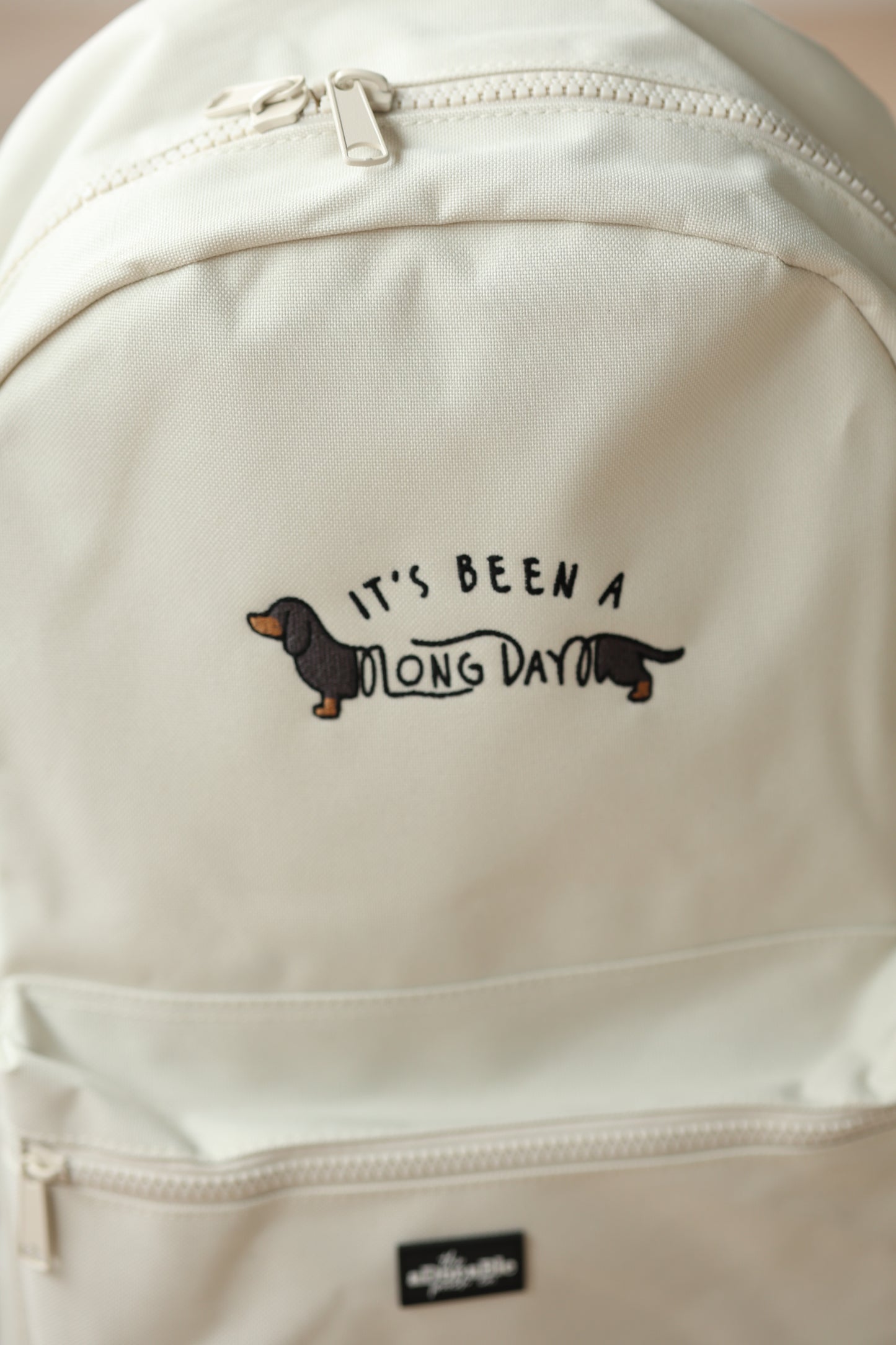 Cream Backpack - It's Been A Long Day - Black and Tan Dachshund - SAMPLE