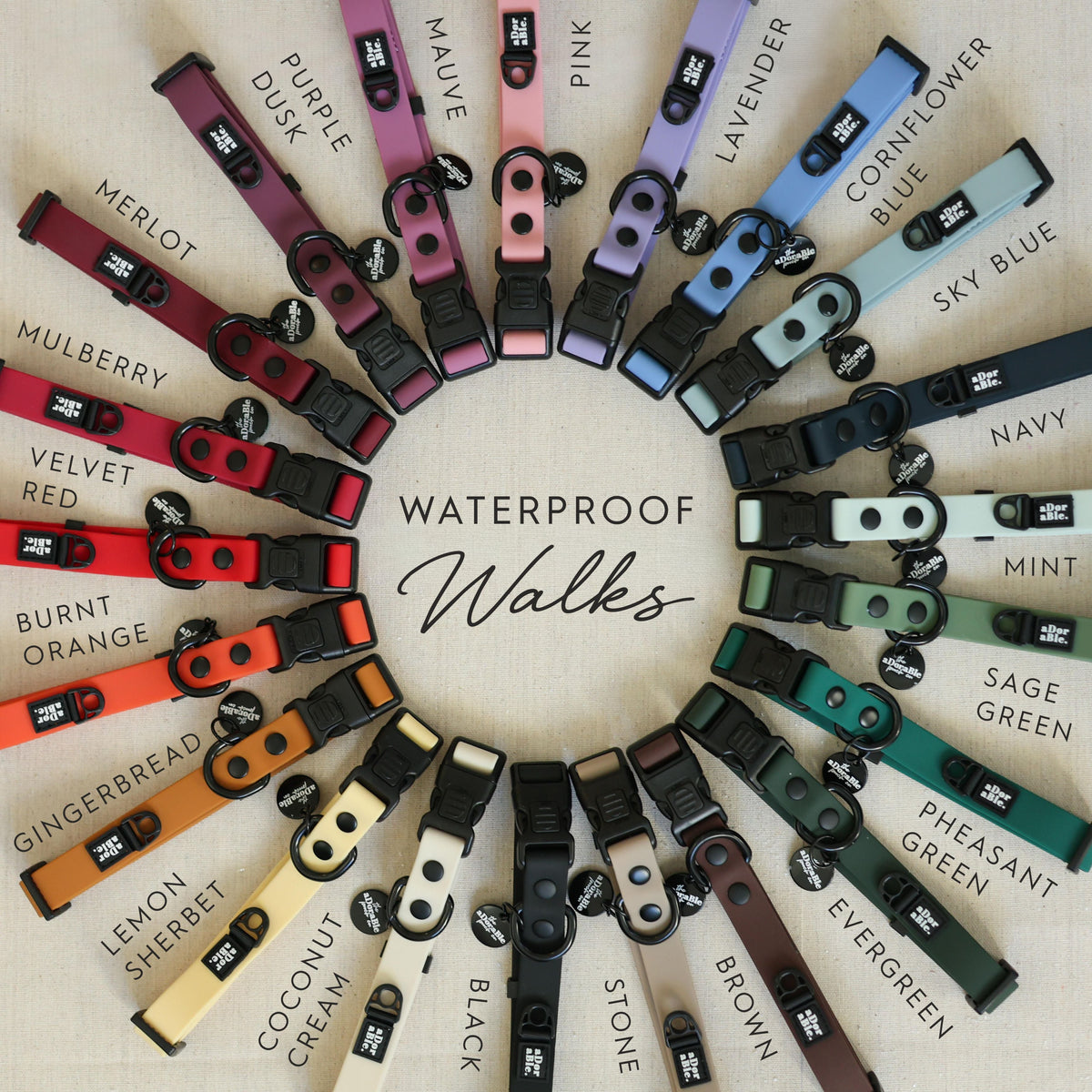 Flat lay of HydroFlex waterproof dog collars arranged in a rainbow wheel layout, showcasing a variety of vibrant colours and styles