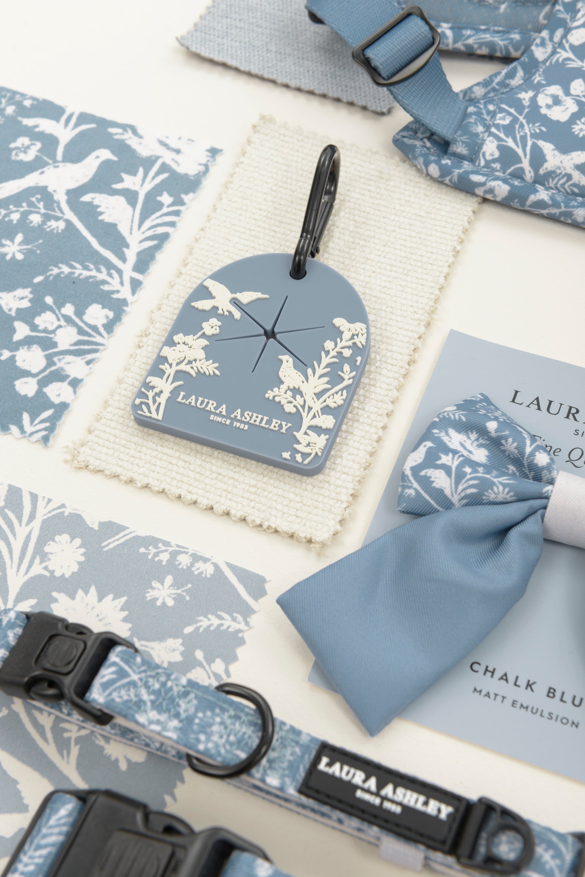 Laura Ashley product set, including sailor bow tie, dog waste carrier and collar, with blue and white floral patterns on a white background