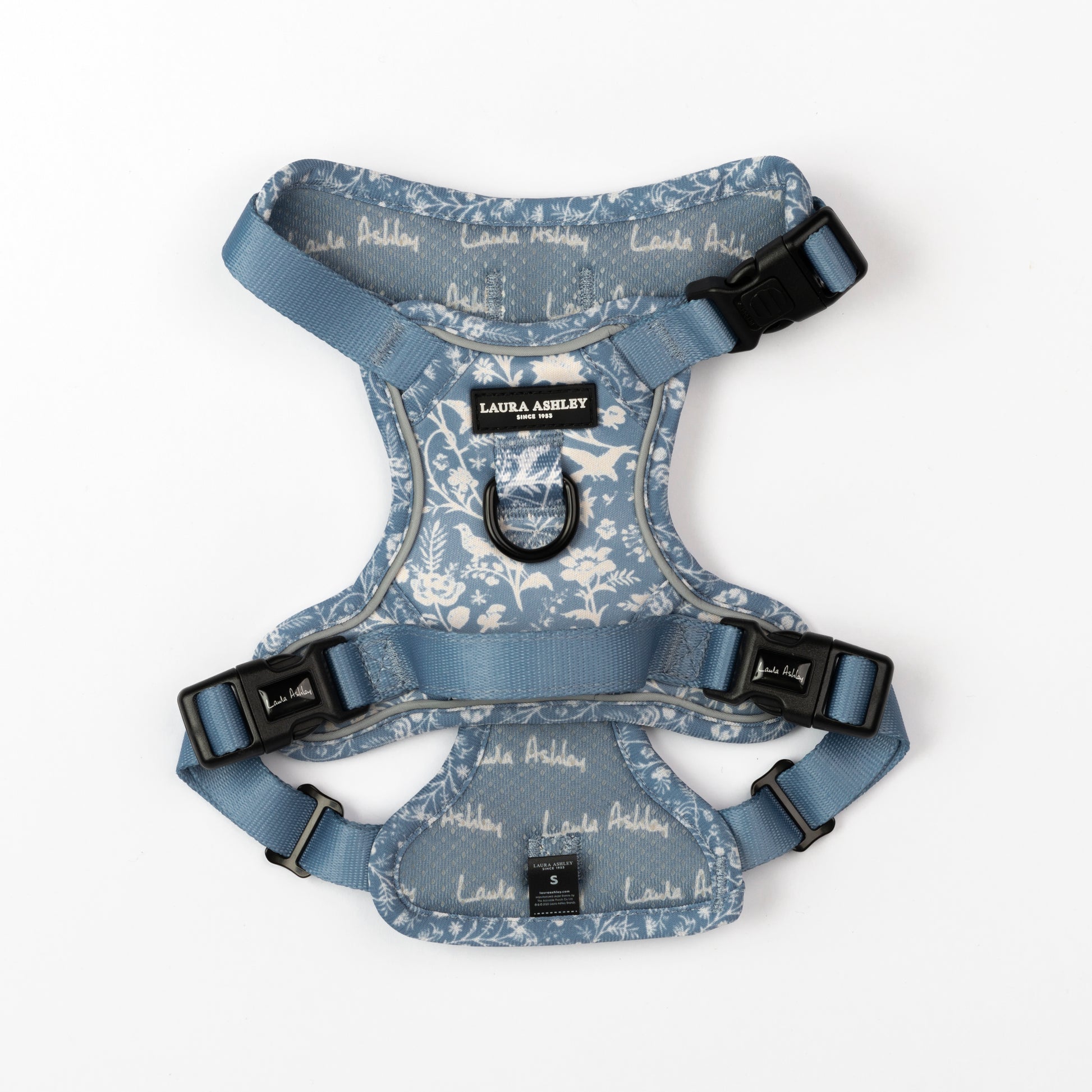 Dog harness with blue and white floral pattern and Laura Ashley branding on a white background