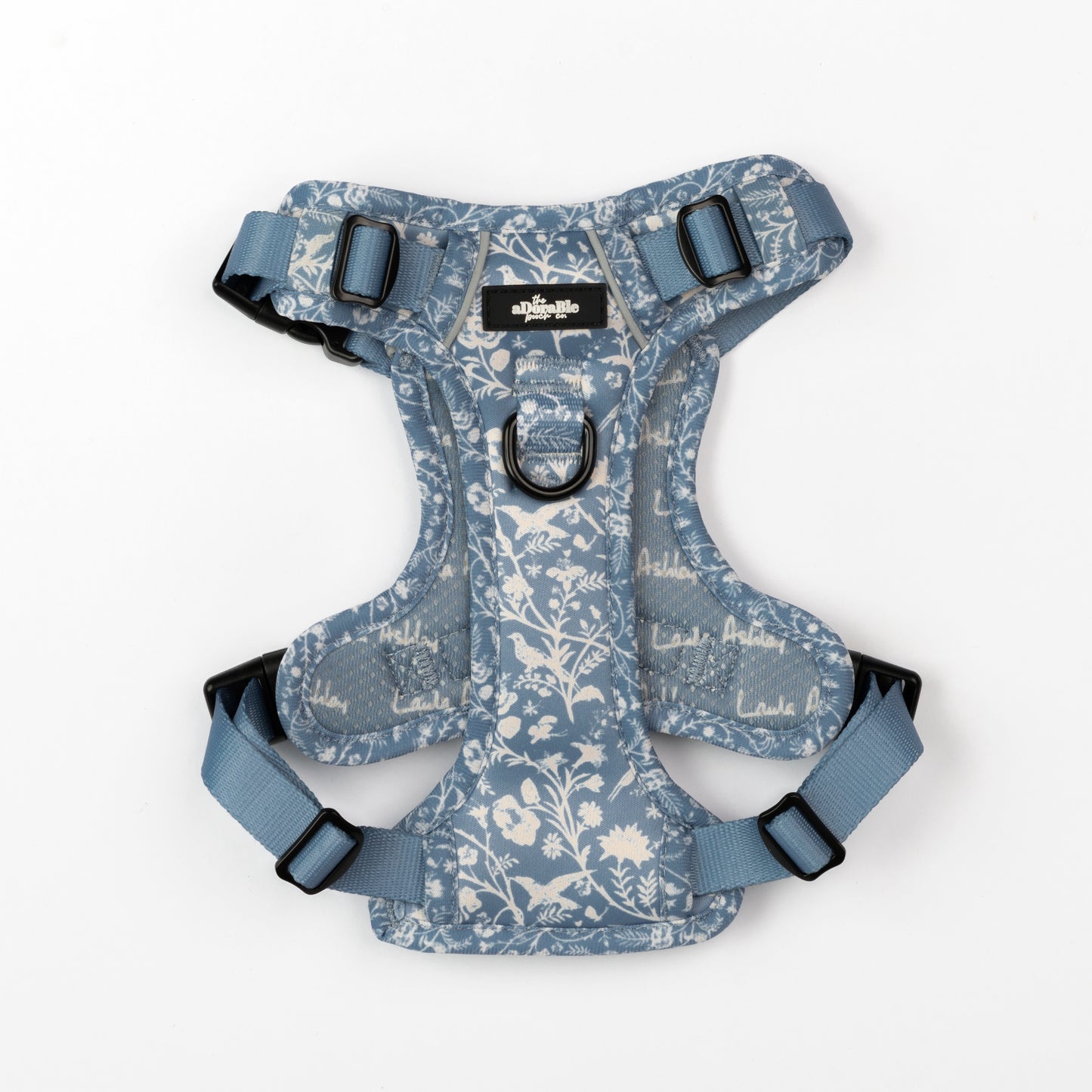Dog harness with blue and white floral pattern on a white background