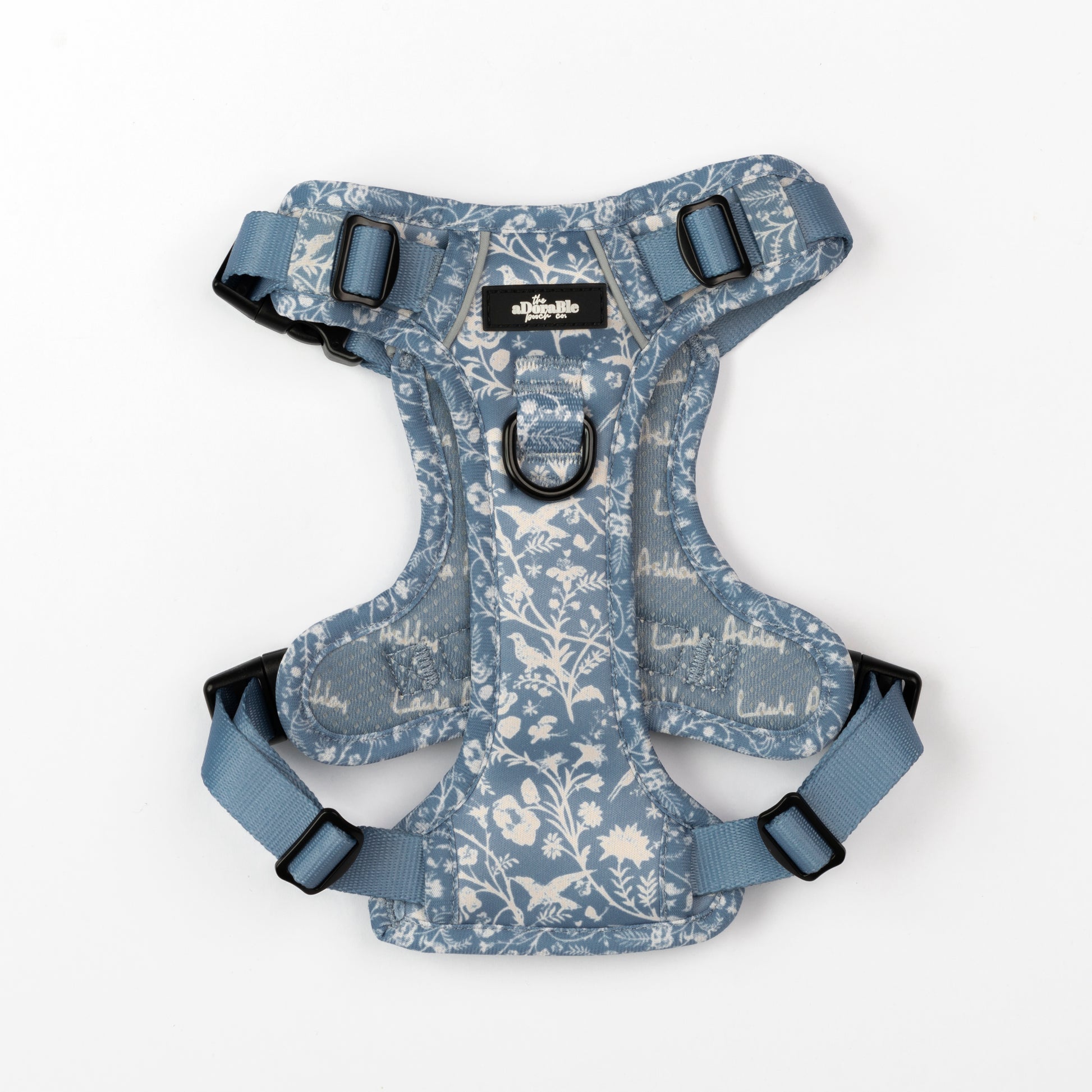 Dog harness with blue and white floral pattern on a white background