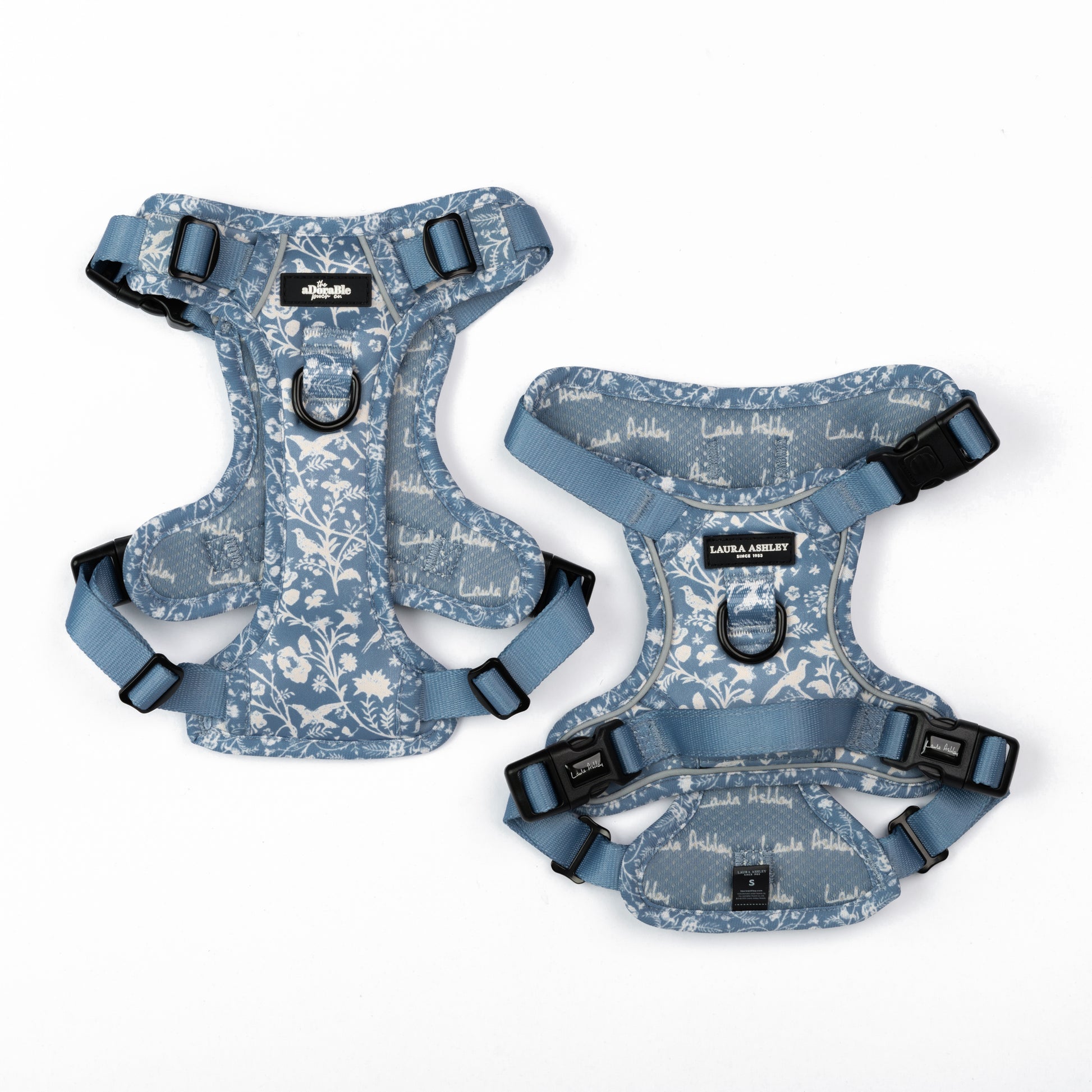 Two floral-patterned dog harnesses on a white background