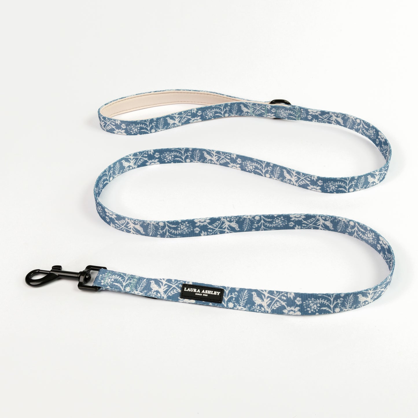 Dog lead with blue and white floral pattern on a white background with Laura Ashley branding and black hardware