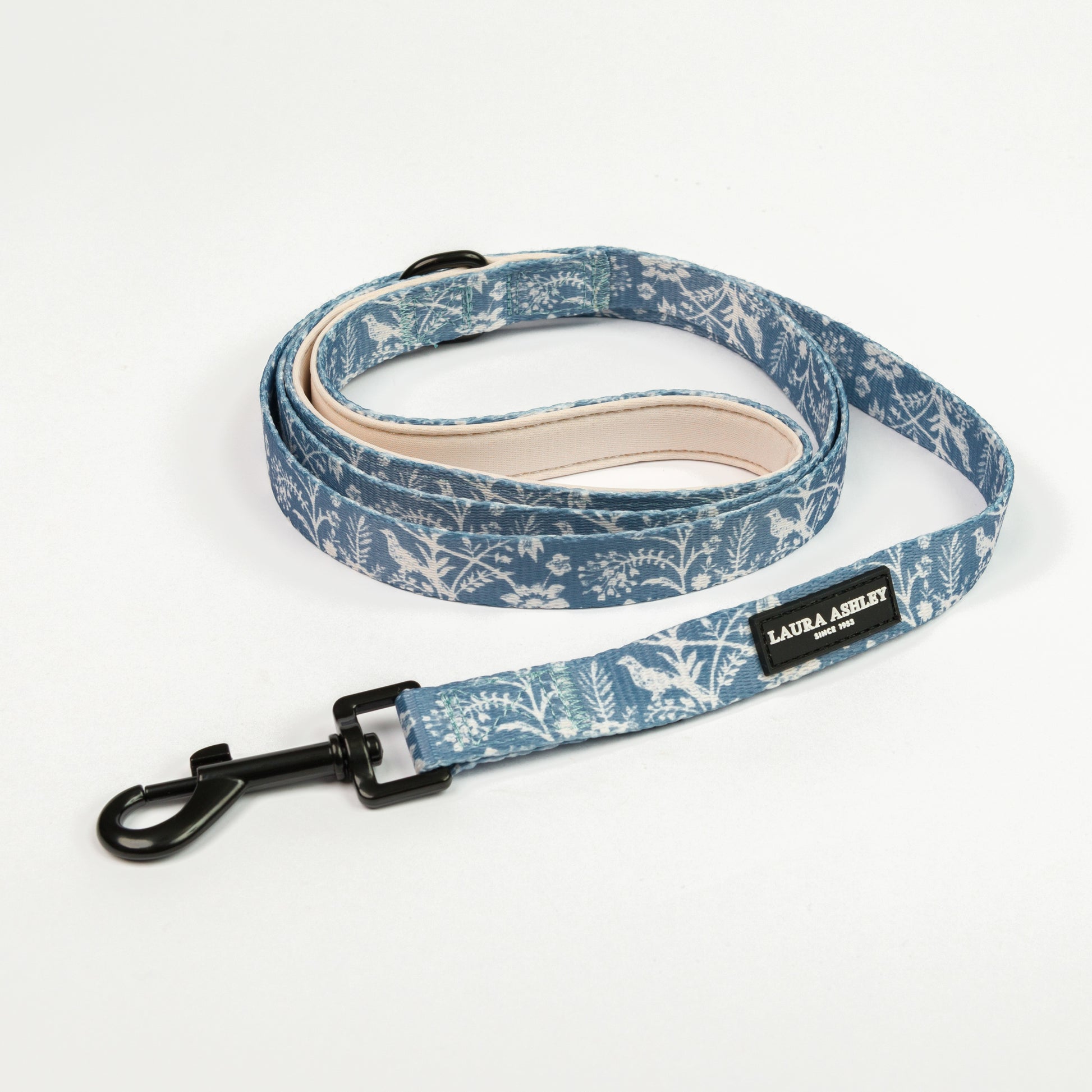Blue Laura Ashley floral patterned dog leash with black hardware and branding on a white background