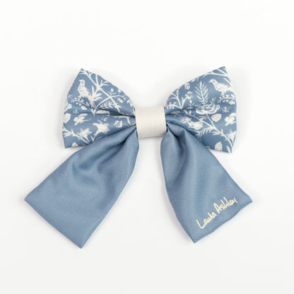 Blue and white sailor bow tie for dogs with Laura Ashley signature embroidery on a white background 