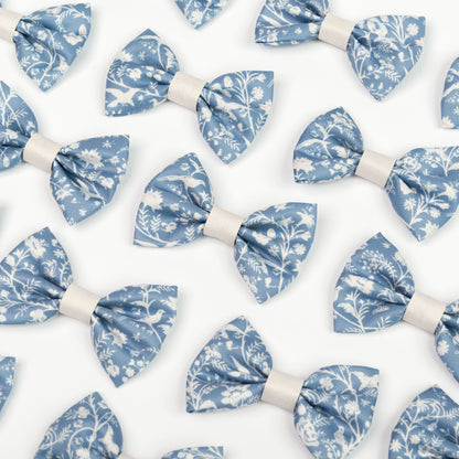 Pattern of blue and white Shepherd's Purse floral dickie bow ties for dogs on a white background