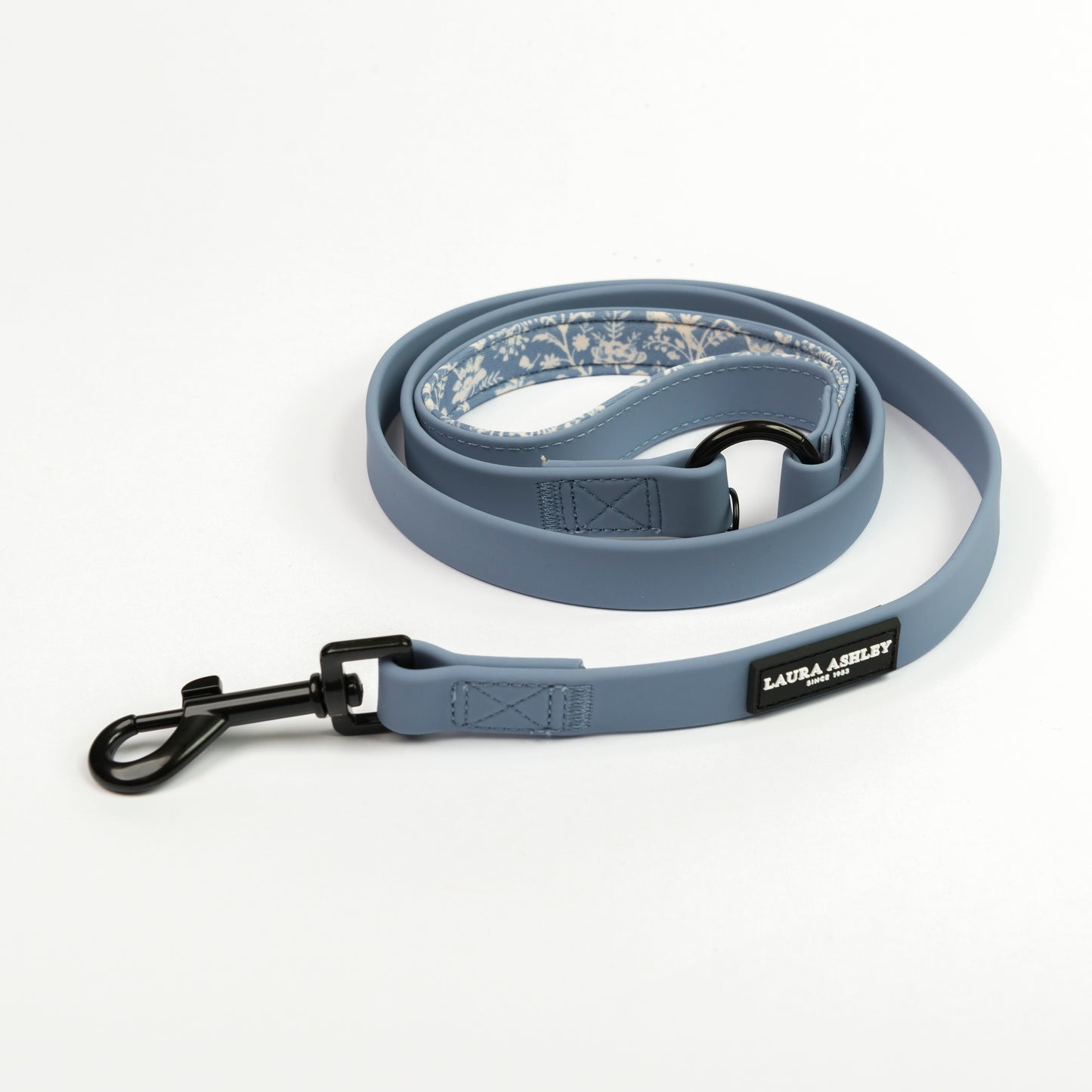 Blue dog lead with floral patterned padded handle on a white background