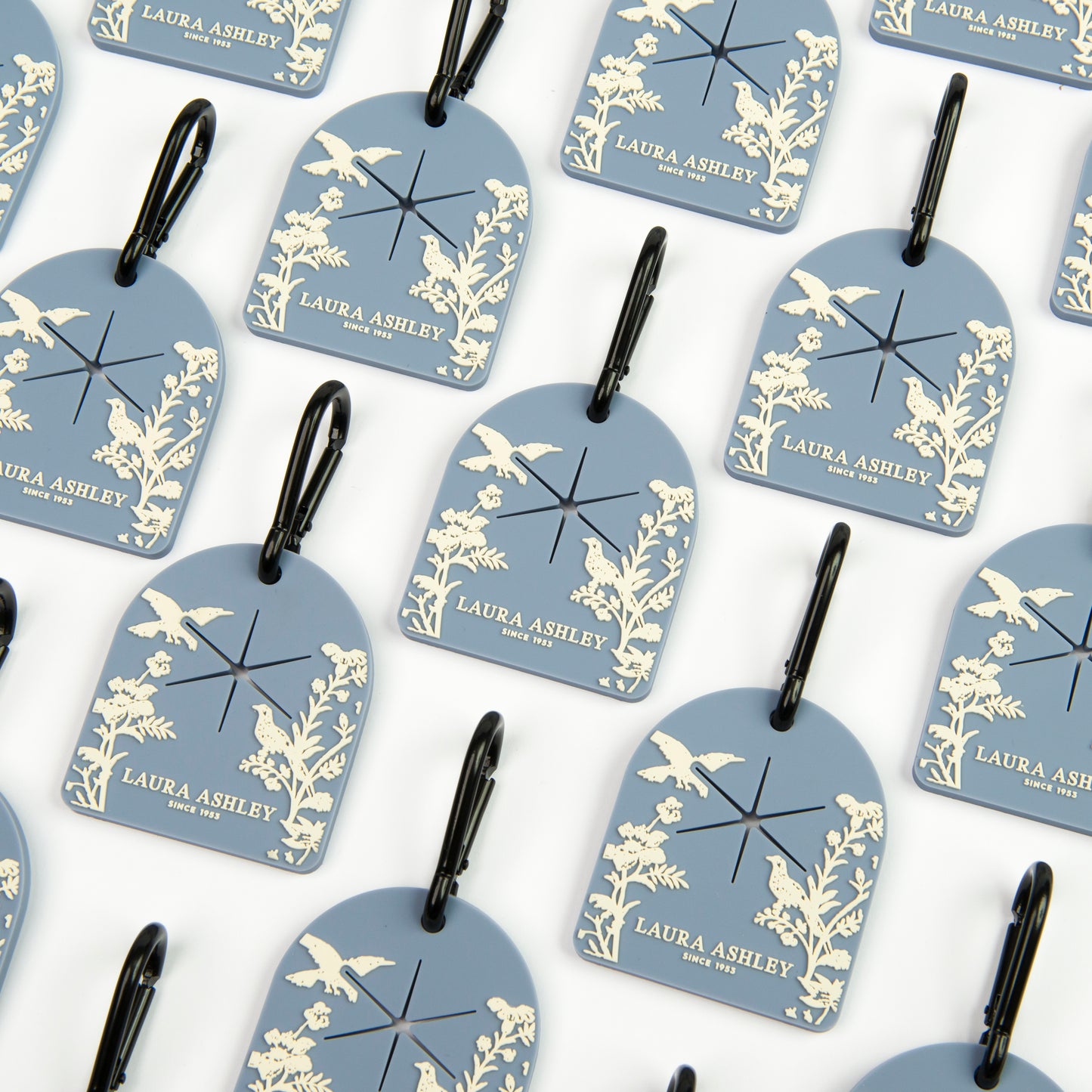 Pattern of blue and white Laura Ashley Shepherd's Purse dog waste bag carriers with decorative designs on a white background