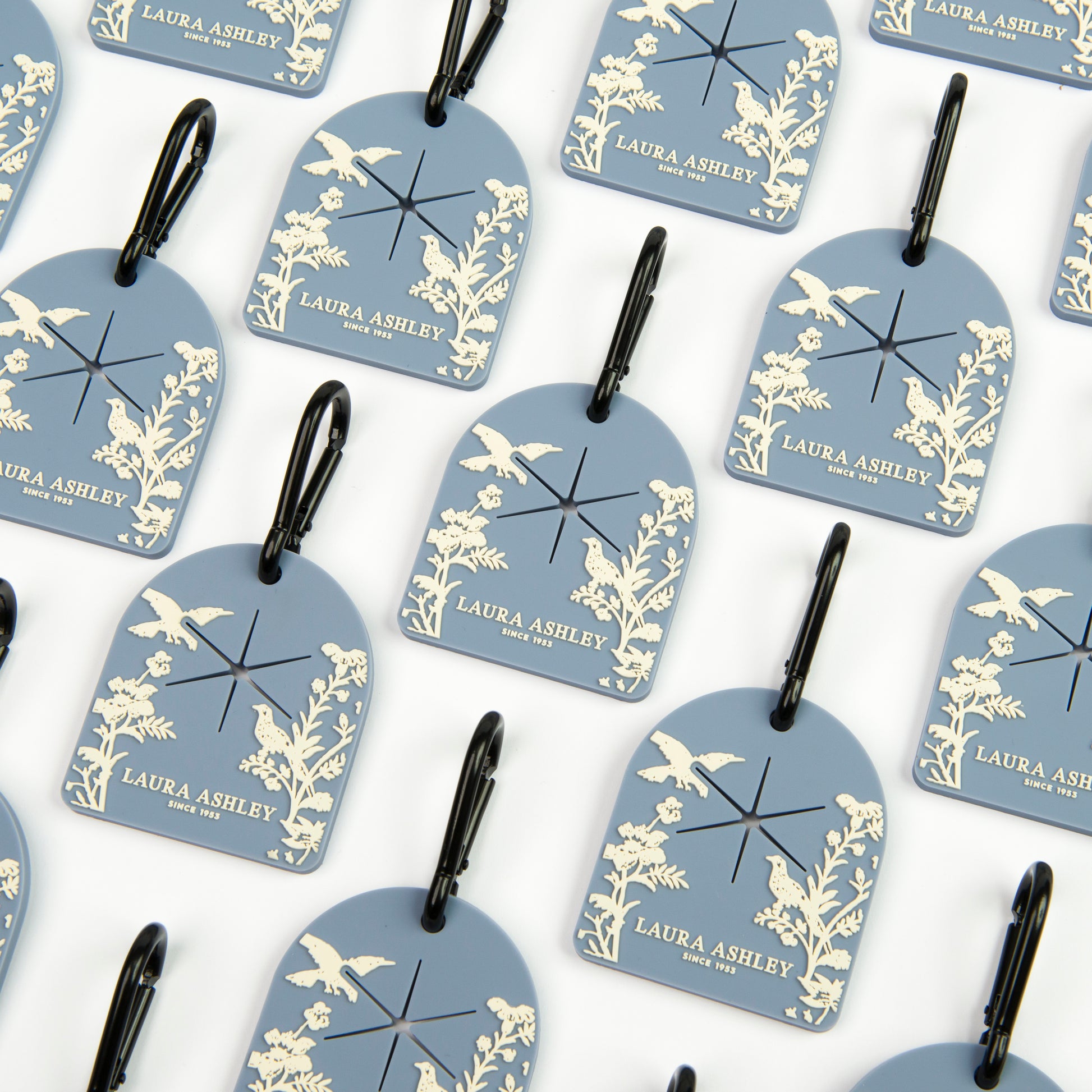 Pattern of blue and white Laura Ashley Shepherd's Purse dog waste bag carriers with decorative designs on a white background