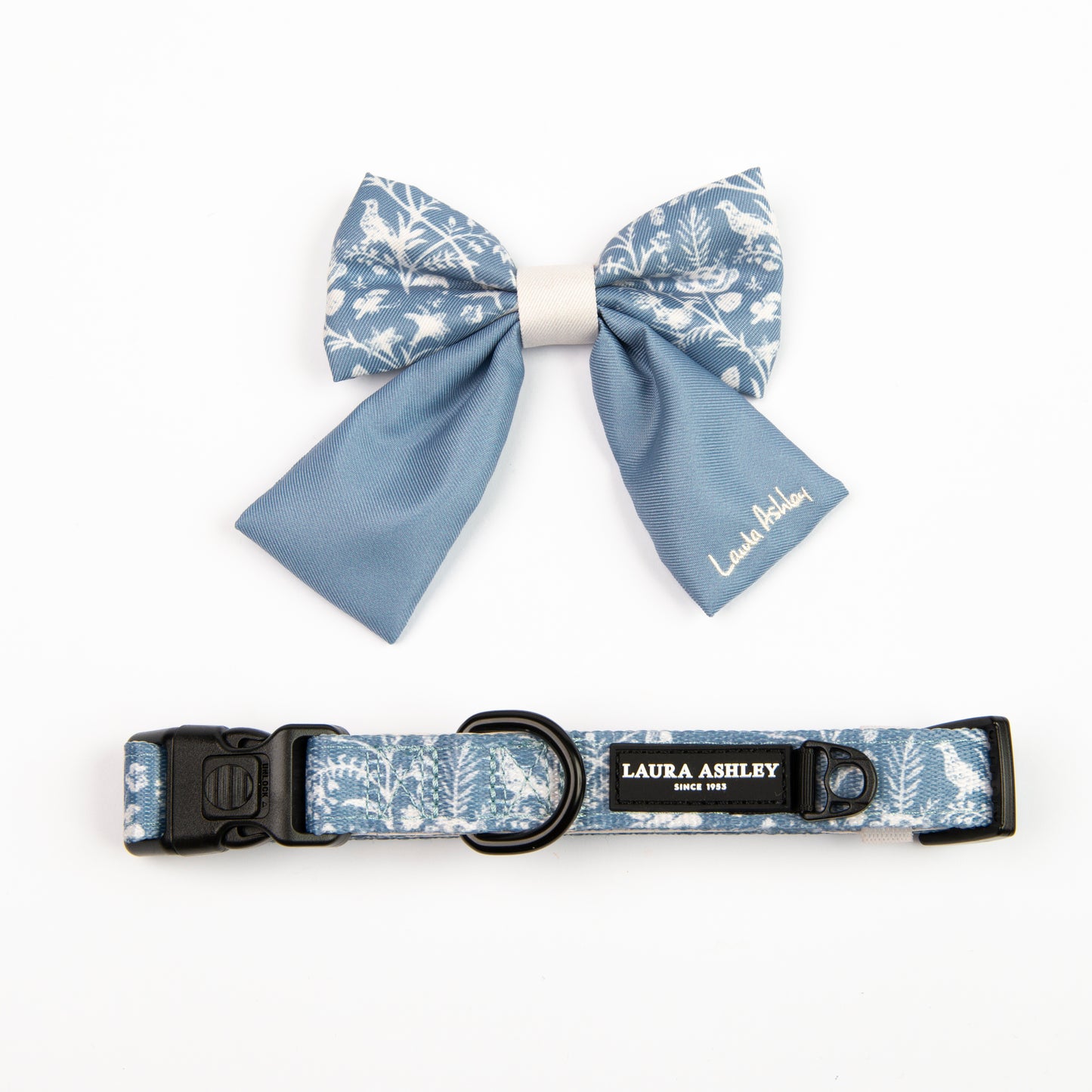 Dog bow tie and collar set with blue and white floral pattern on a white background