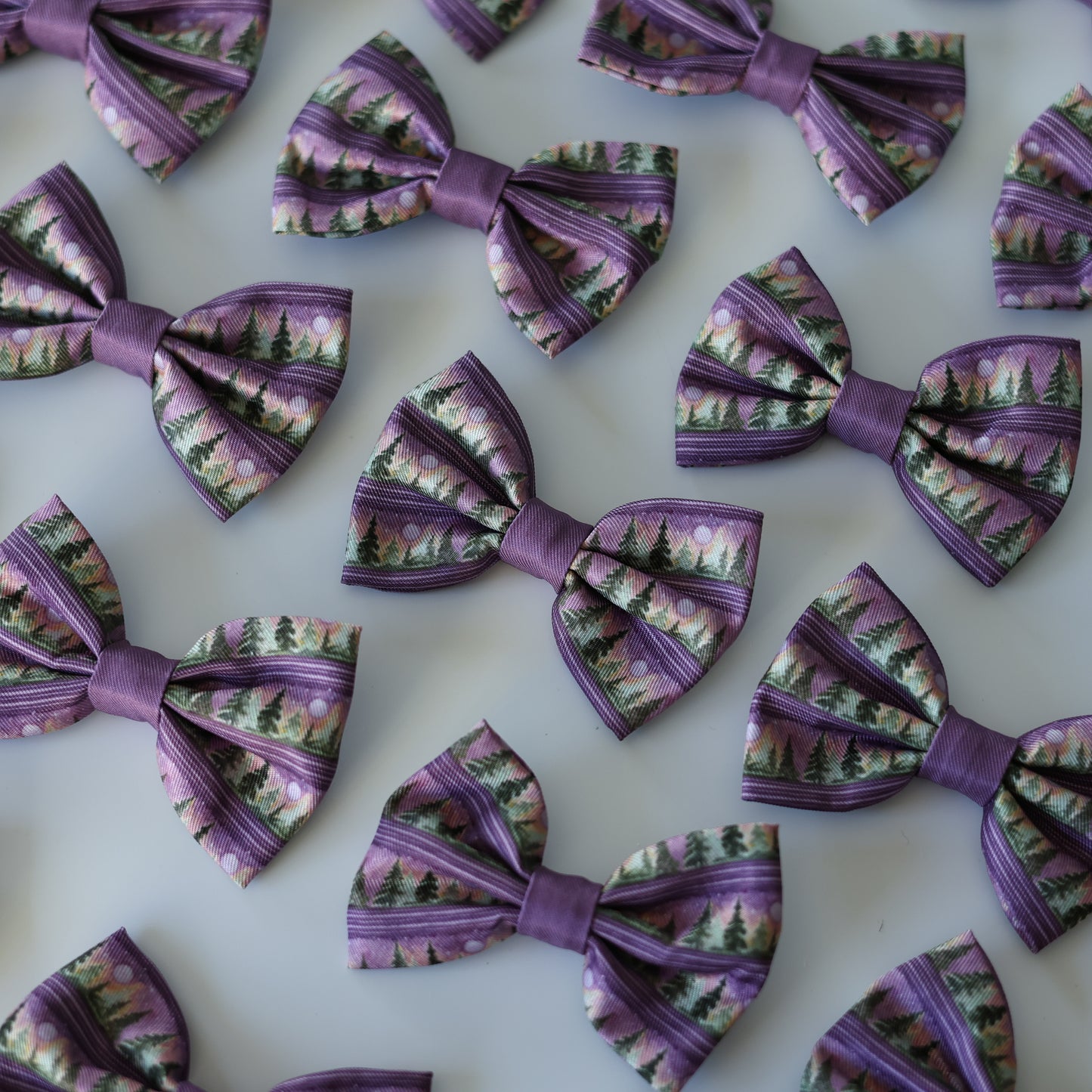 Purple patterned bows arranged on a white background