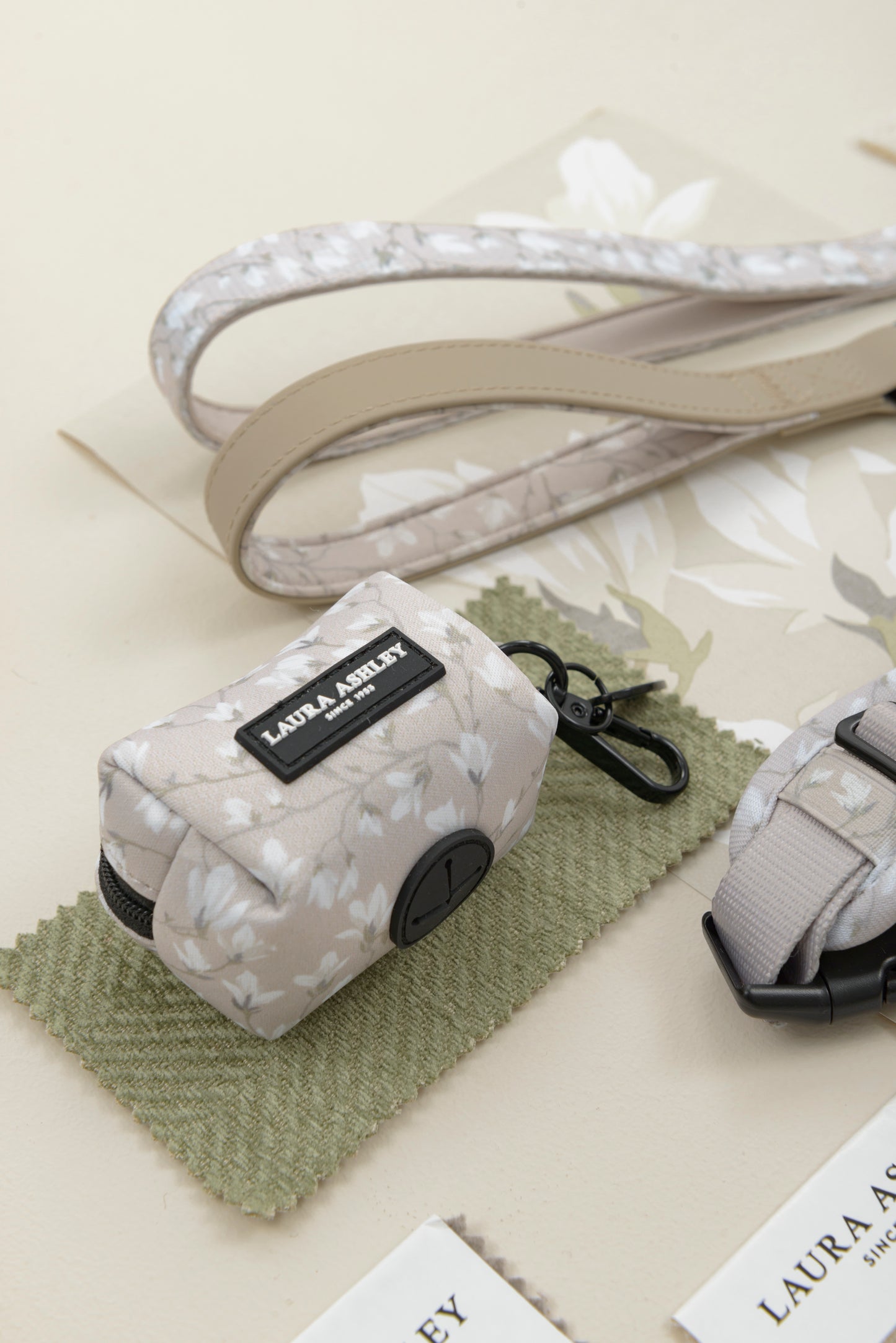 Dog lead and dog waste bag dispenser in Magnolia Grove Laura Ashley branding on a light background